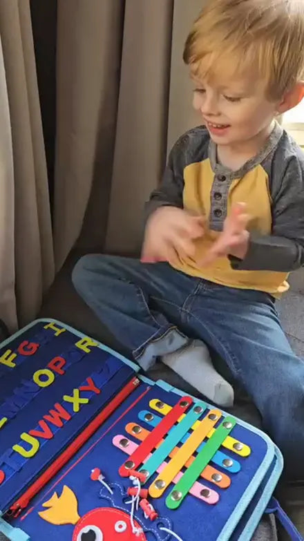 Child playing with the Doolo busy board