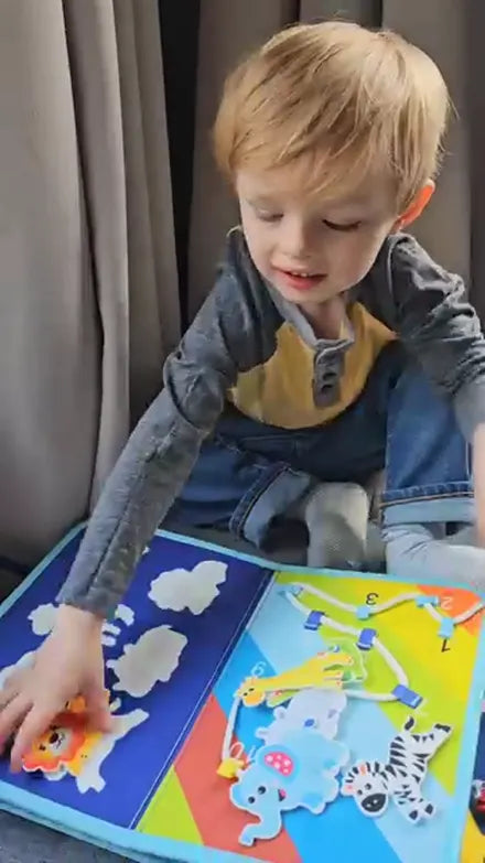 Child playing with the Doolo busy board