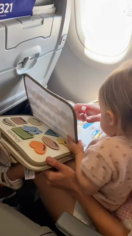Child playing with the Doolo busy board