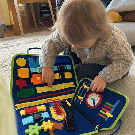 Child playing with the Doolo busy board